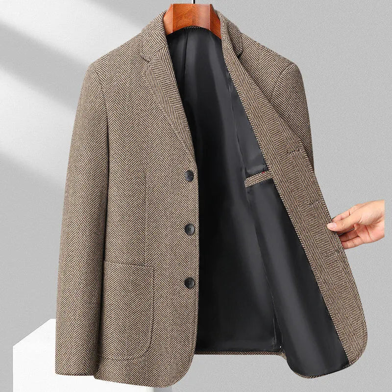 A man wearing a solid colour loose-fit wool blend coat suitable for spring or autumn.
