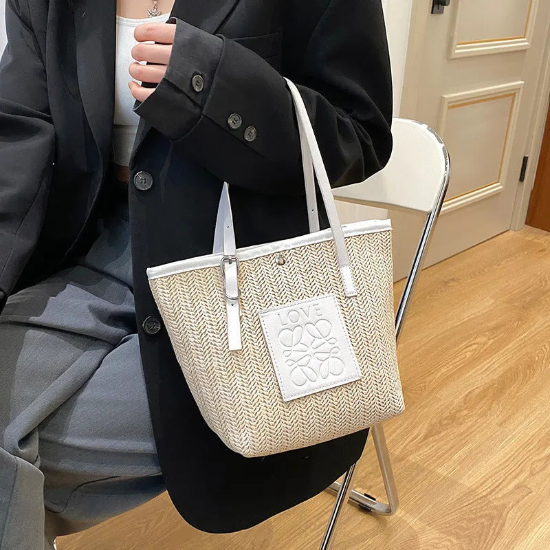 Straw woven women's shoulder bag in black with three-dimensional pocket and 27cm width
