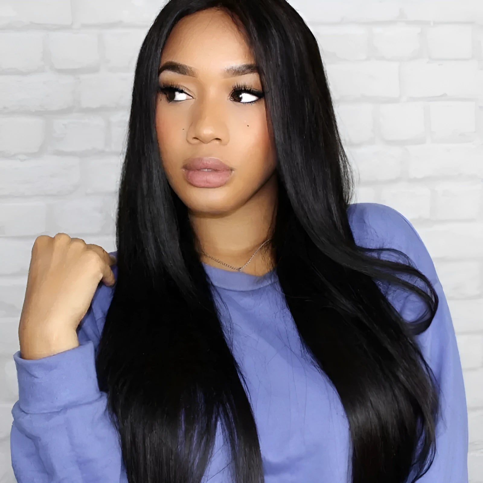 Long straight black wig with centre part and bangs on a mannequin head