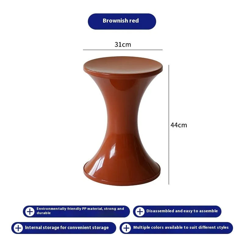 Hourglass-shaped plastic stool in green for changing shoes, used by an adult and child.
