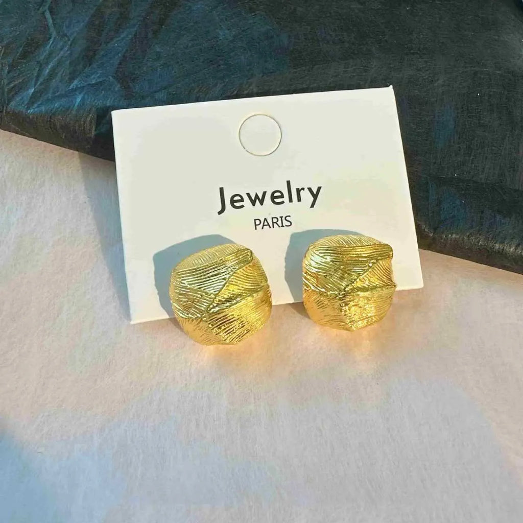 Minimalist metal alloy stud earrings with a simple circle design on a white background.