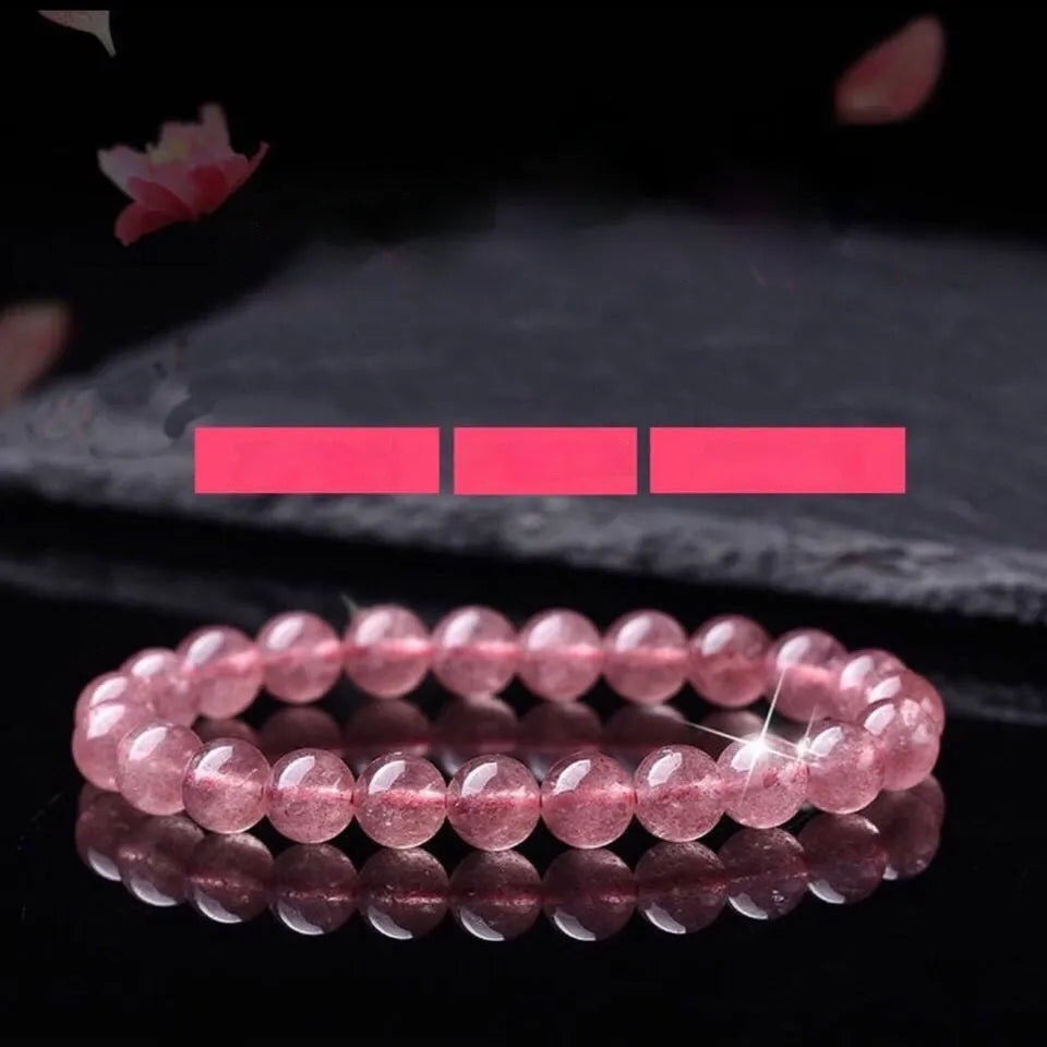 Women's strawberry quartz bracelet with polished beads in 6mm, 8mm, or 10mm sizes.