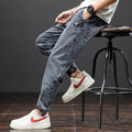 Men's loose fit cargo jeans in Korean style, showing straight leg and mid-waist design.