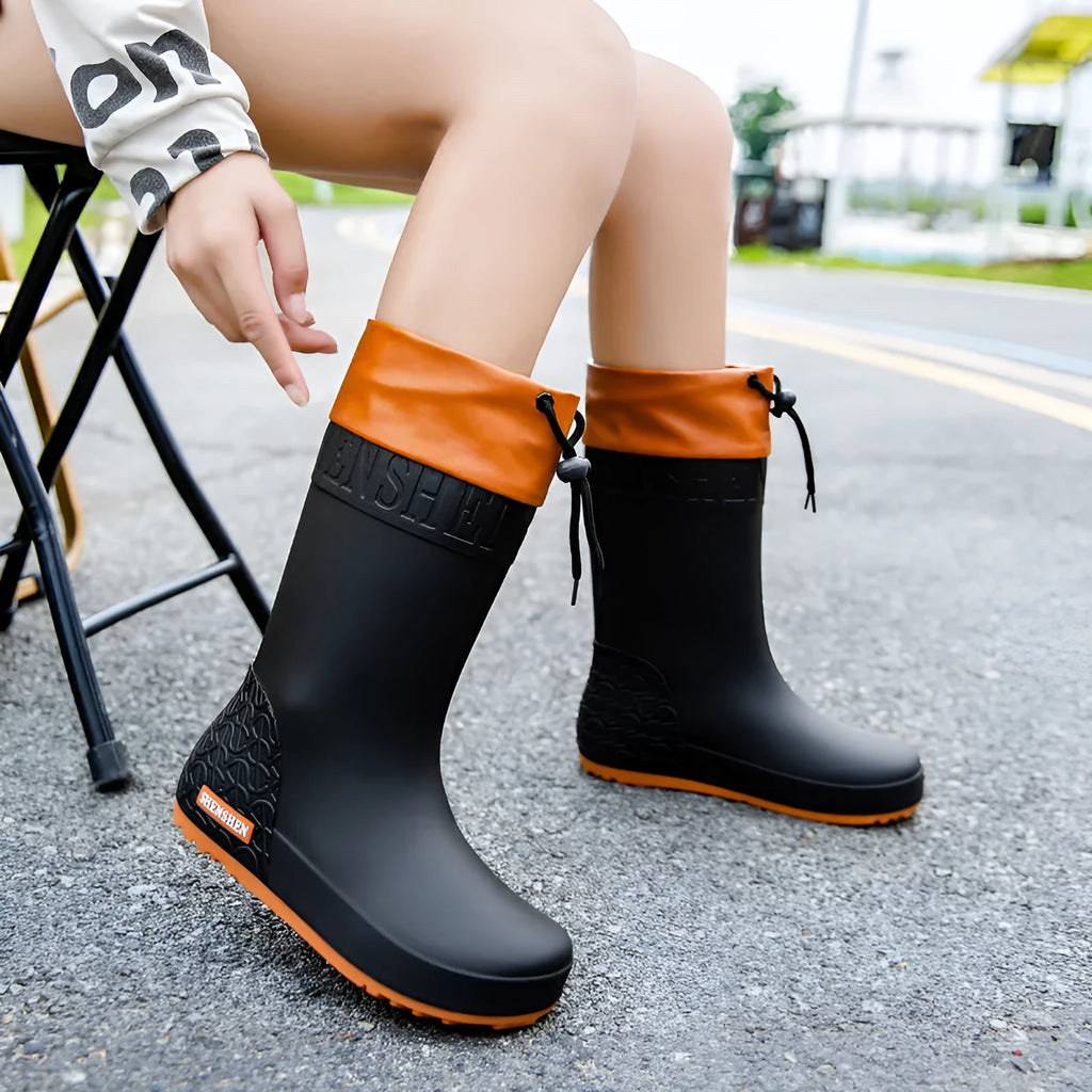 Women's PVC rain boots with non-slip soles in apricot, black, brown, and pink colour options