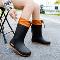 Women's PVC rain boots with non-slip soles in apricot, black, brown, and pink colour options