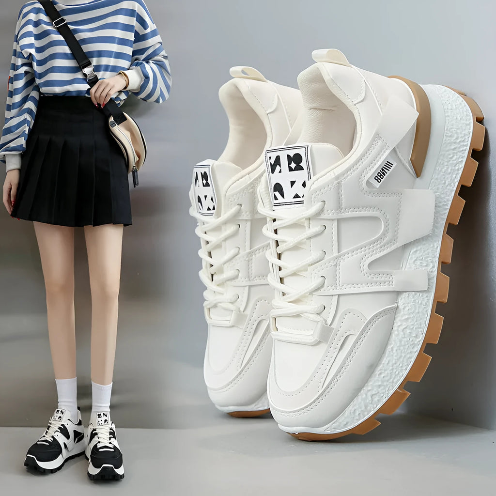 Low-top white and black casual sneakers with round toe and lace-up front