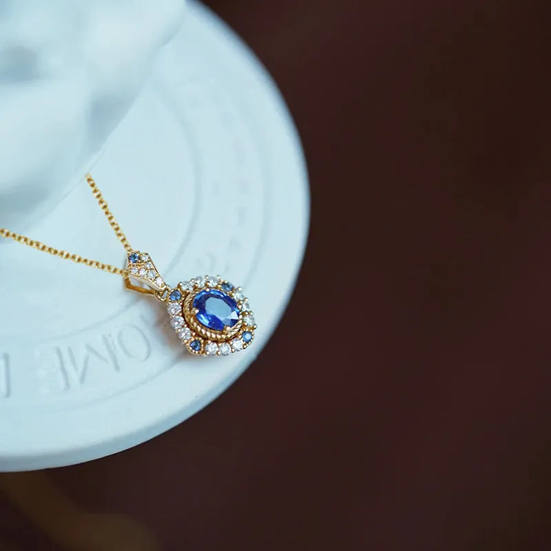 Yellow gold royal necklace with mixed gem inlaid pendant on a copper box chain, adjustable length.