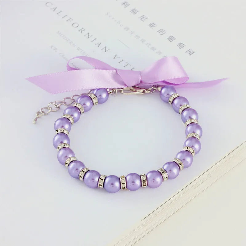 Adjustable pearl and rhinestone dog necklace on a soft ribbon in blue colour