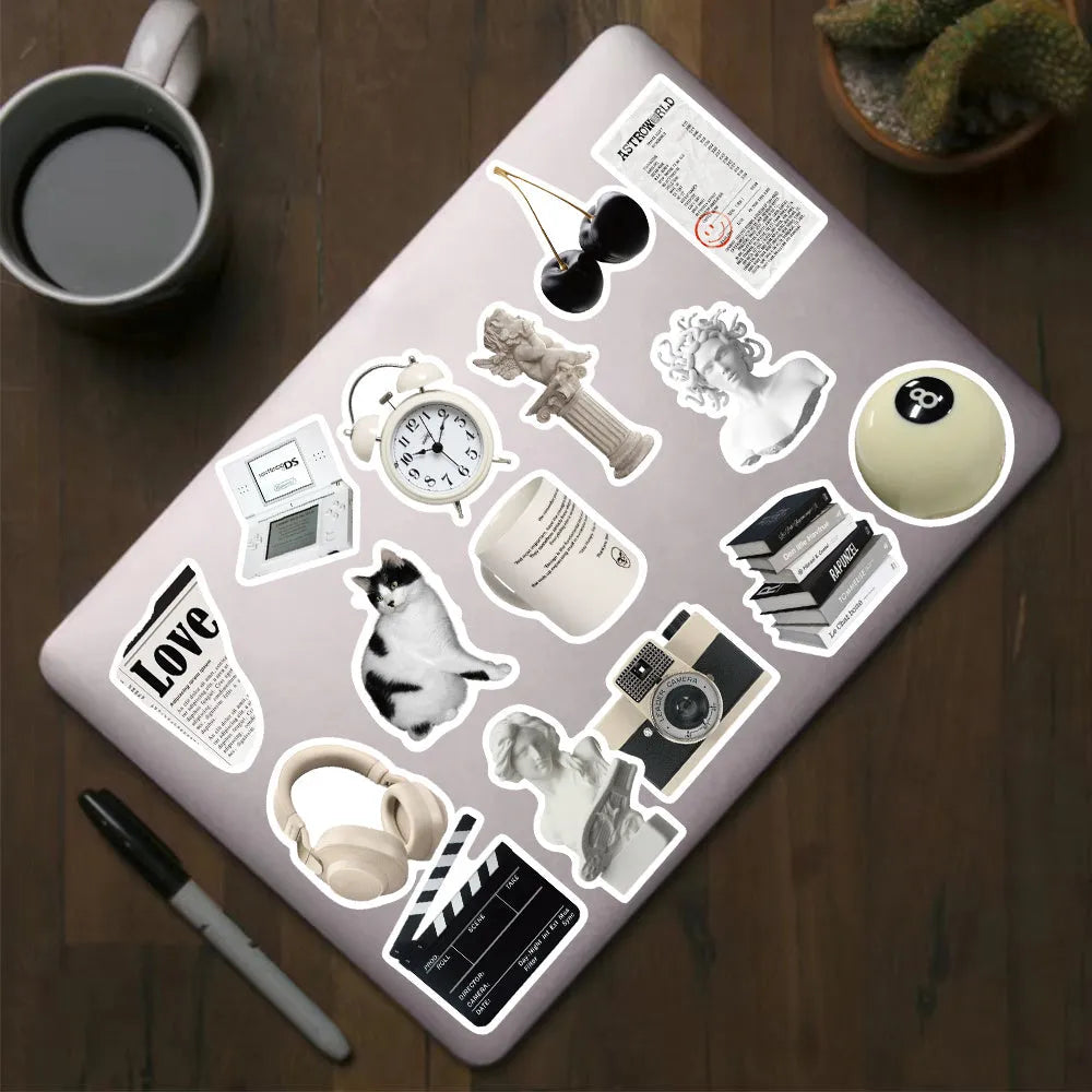 Pack of 61 black and white waterproof PVC stickers for laptops and drinkware.