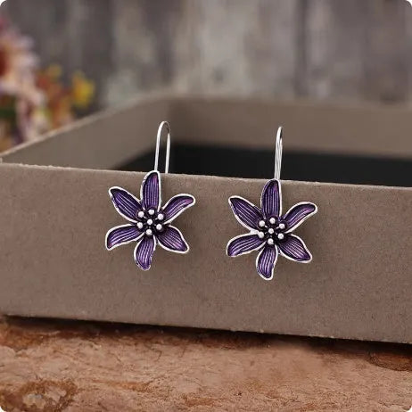 A pair of retro-style purple flower earrings made from lightweight alloy with an electroplated finish.