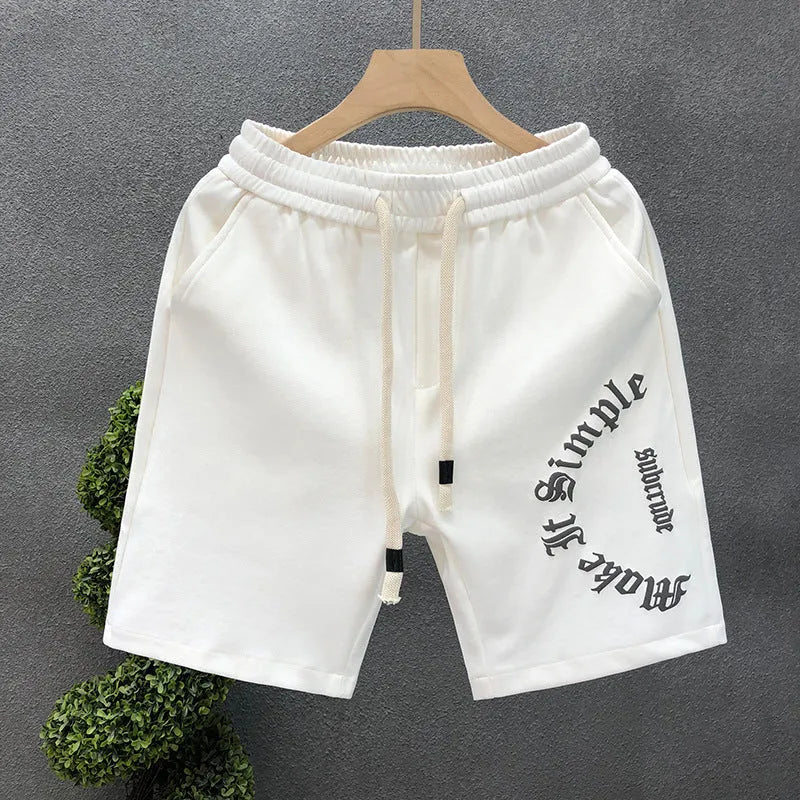 Printed cropped polyester sports pants in black for teenage men, side view showing cropped leg length