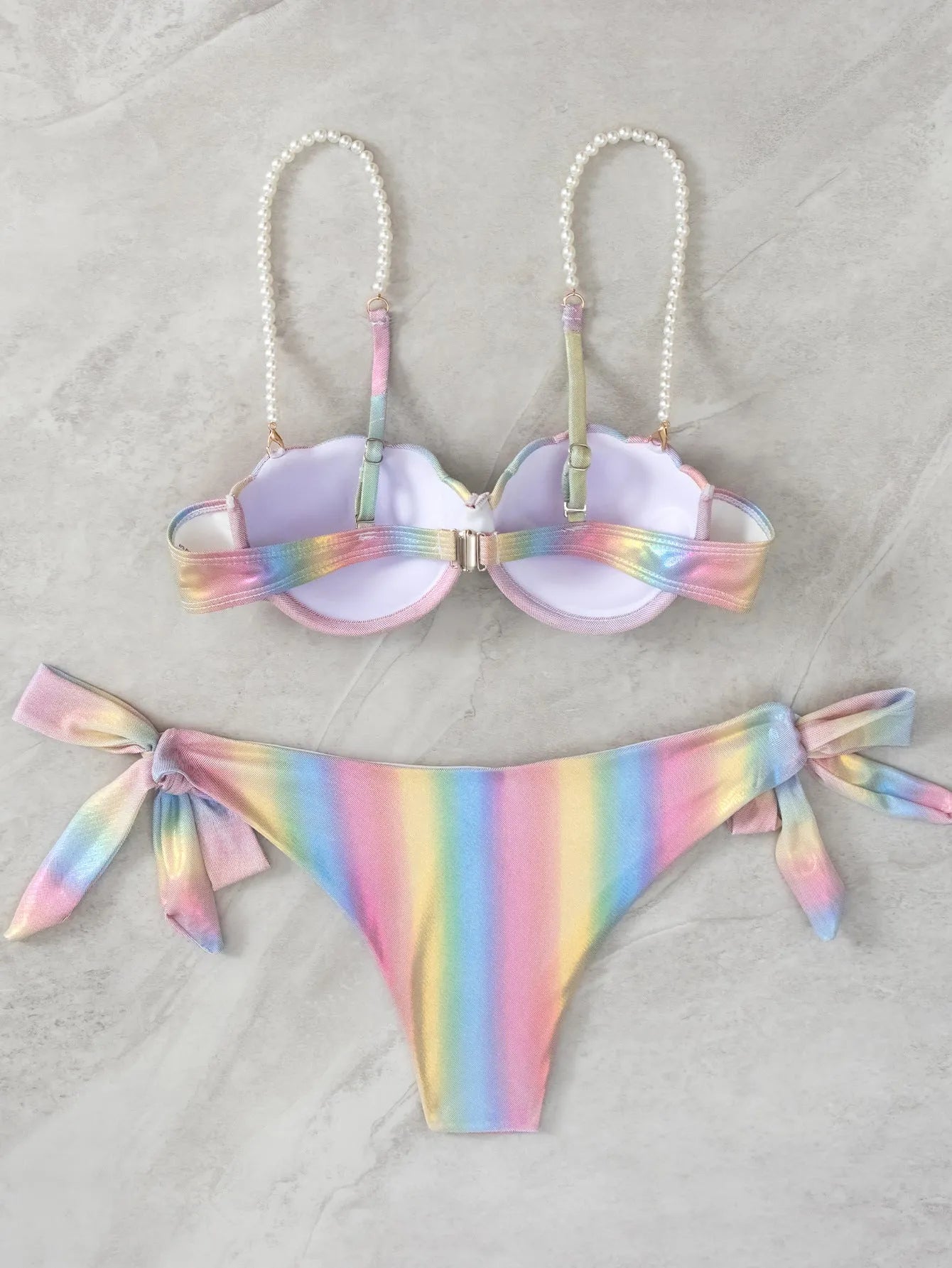 Women's rainbow coloured split tied bikini swimsuit set on a mannequin.