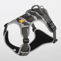 Orange reflective dog chest and back harness with hand-holding rope on a neutral background.