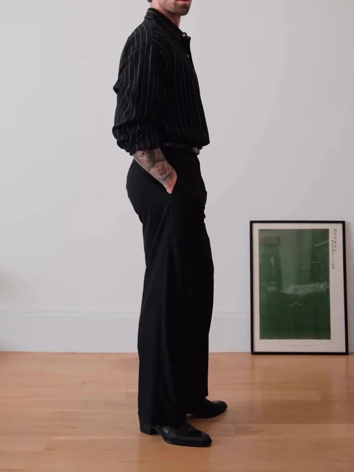 Black pinstriped polyester button-down shirt with regular fit on hanger