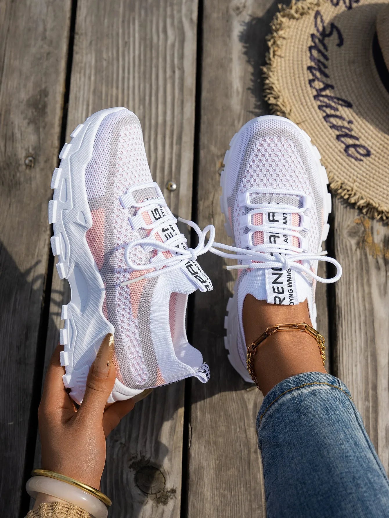 Women's Flyknit mesh lace-up sneakers in a selection of colours, showing round toe and flat rubber sole.
