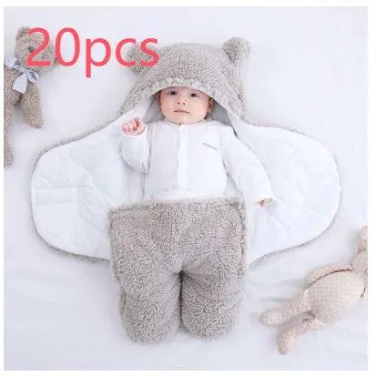 Baby quilted sleeping bag wrapper in cotton blend fabric, shown in grey colour with size tag.