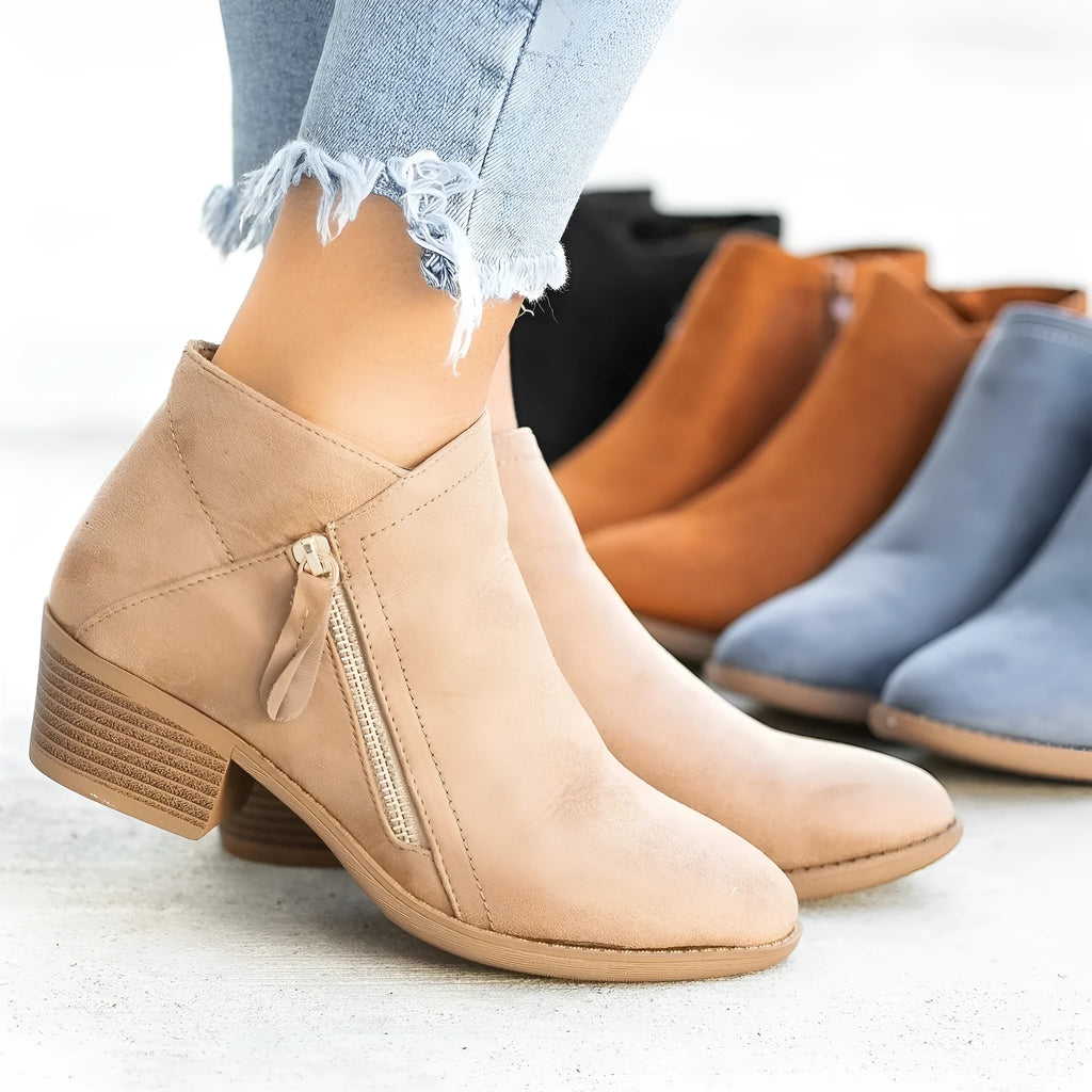 Blue suede women's ankle boots with a side zip and chunky composite sole, shown from the side.