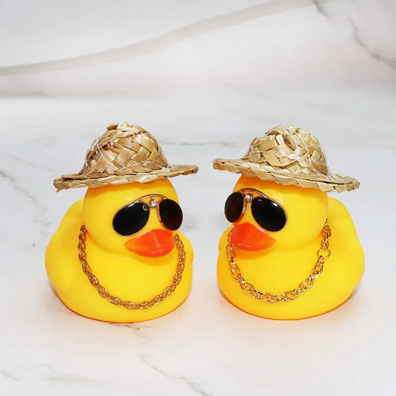 Cartoon yellow duck car ornament wearing a straw hat and sunglasses