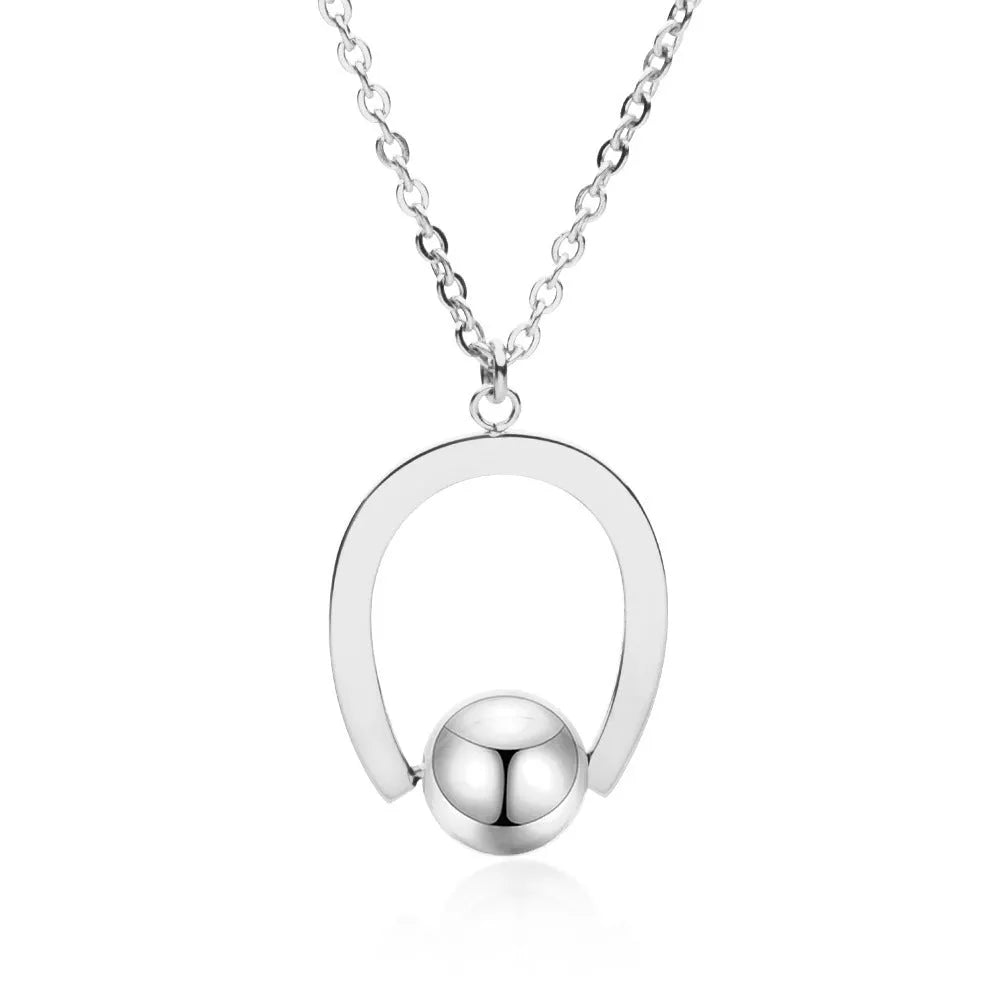 Gold or silver electroplated stainless steel geometric pendant necklace on a cross chain.