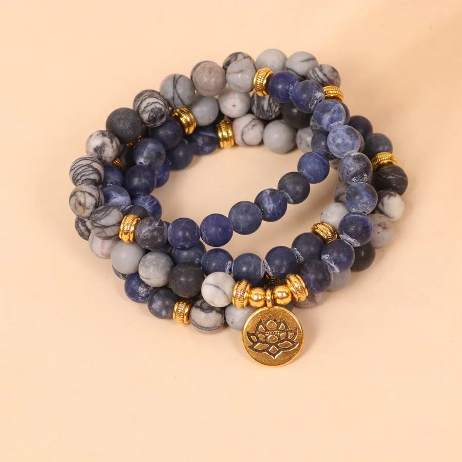 Blue multi-layer bracelet with patterned network stone beads on an alloy chain.
