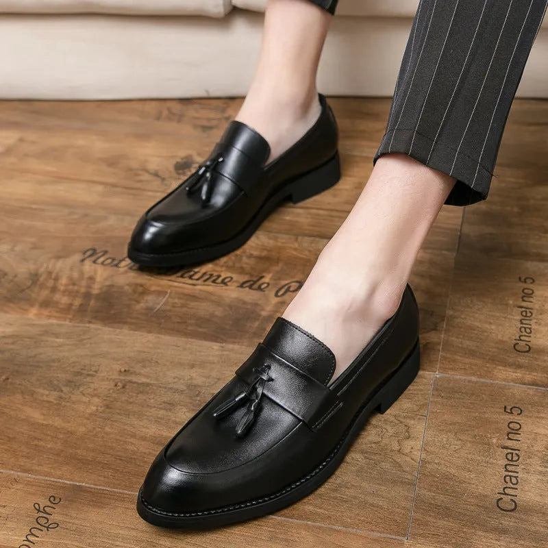 Men's black slip-on loafers with tassel detail and rubber sole for business casual wear