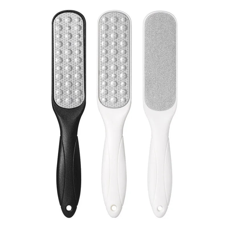 Double-sided stainless steel foot grinder with black and white grit attachments for callus removal