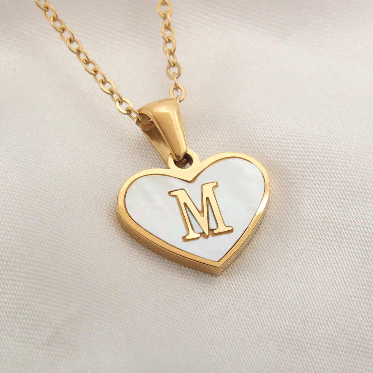 Gold heart necklace with white shell pendant and initial charm on 45cm adjustable chain