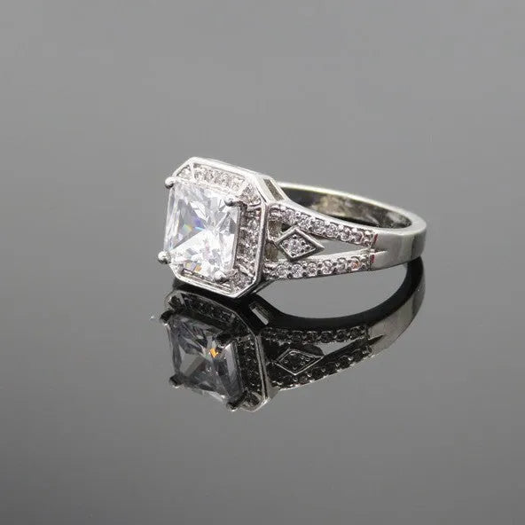 Women's geometric zircon ring with platinum finish on a copper band, showing hollow construction and quadrilateral design.