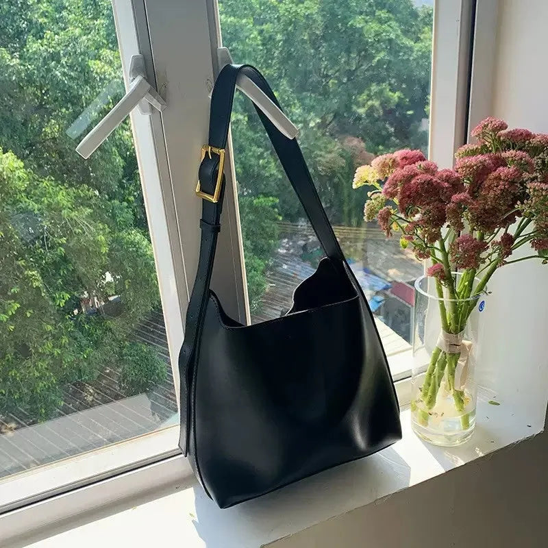 Women's soft PU shoulder bag with swing threads decoration in black or brown colour