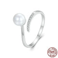 Silver adjustable ring with shell pearls showing open loop design for size adjustment