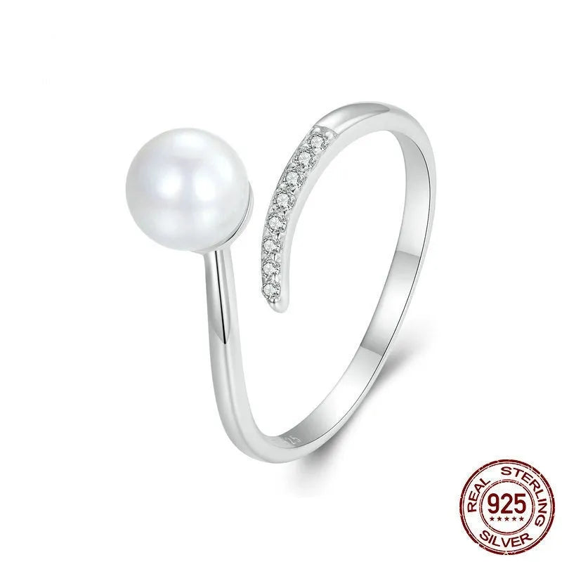 Silver adjustable ring with shell pearls showing open loop design for size adjustment