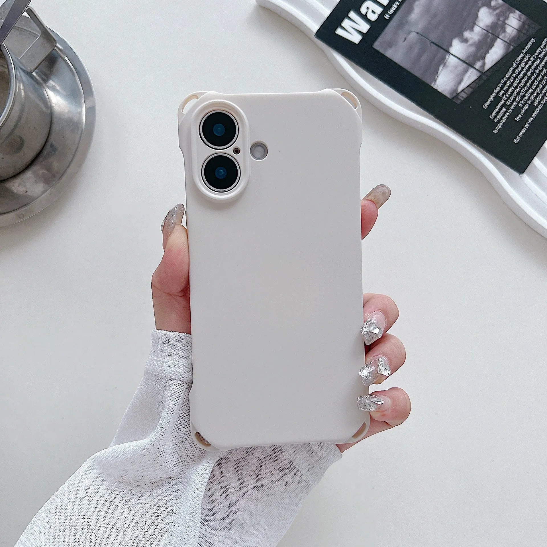 Four-corner cross lanyard liquid silicone phone case for Apple iPhone 16 in antique white with matching lanyard