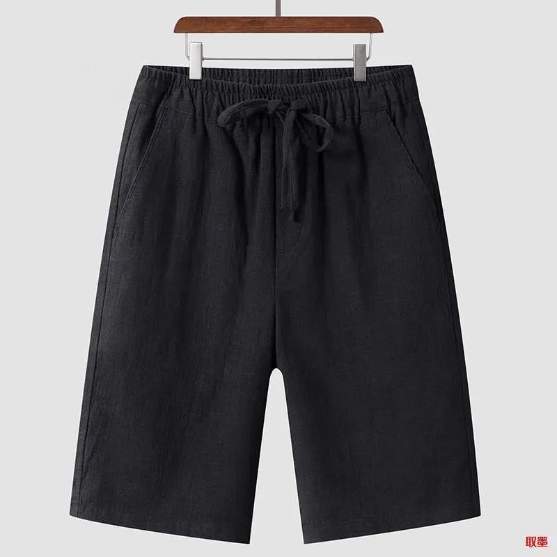 Men's beige linen casual shorts with loose cropped fit and elastic waistband on a neutral background.