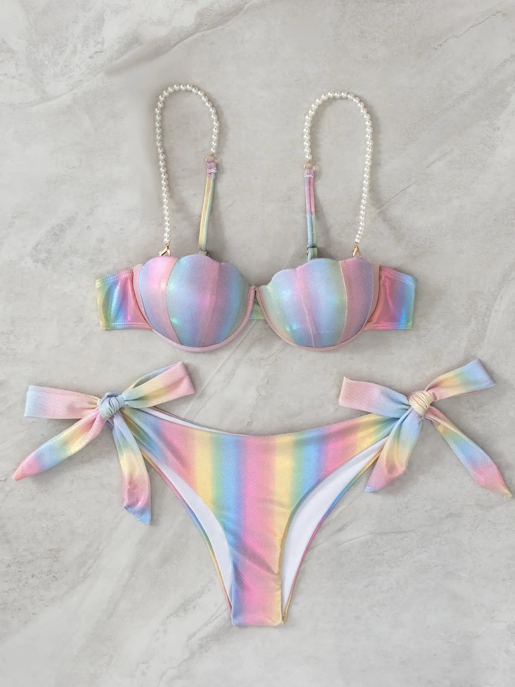 Women's rainbow coloured split tied bikini swimsuit set on a mannequin.