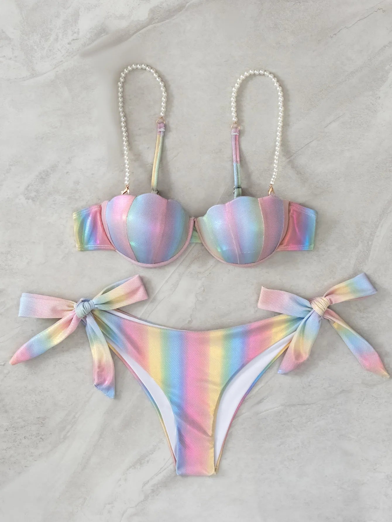 Women's rainbow coloured split tied bikini swimsuit set on a mannequin.