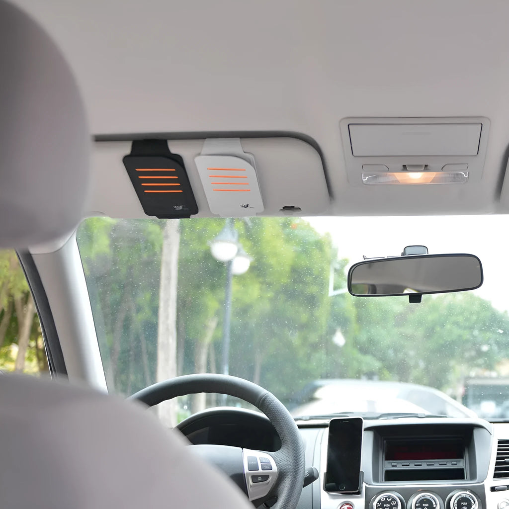 Set of four grey car sun visor card holder tablets next to a vehicle-mounted storage bag.
