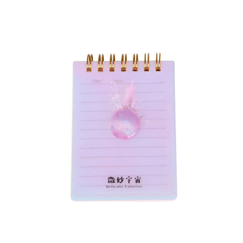 Set of four A7 spiral-bound notebooks with PP covers in different designs, showing compact 10.8 x 8.2 cm size