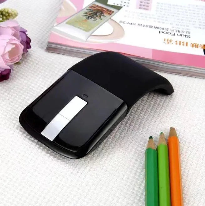 Folding wireless Bluetooth mouse showing compact design with touch surface and portable folded position