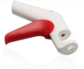 Cherry and olive pitting tool with red silicone handles and stainless steel mechanism