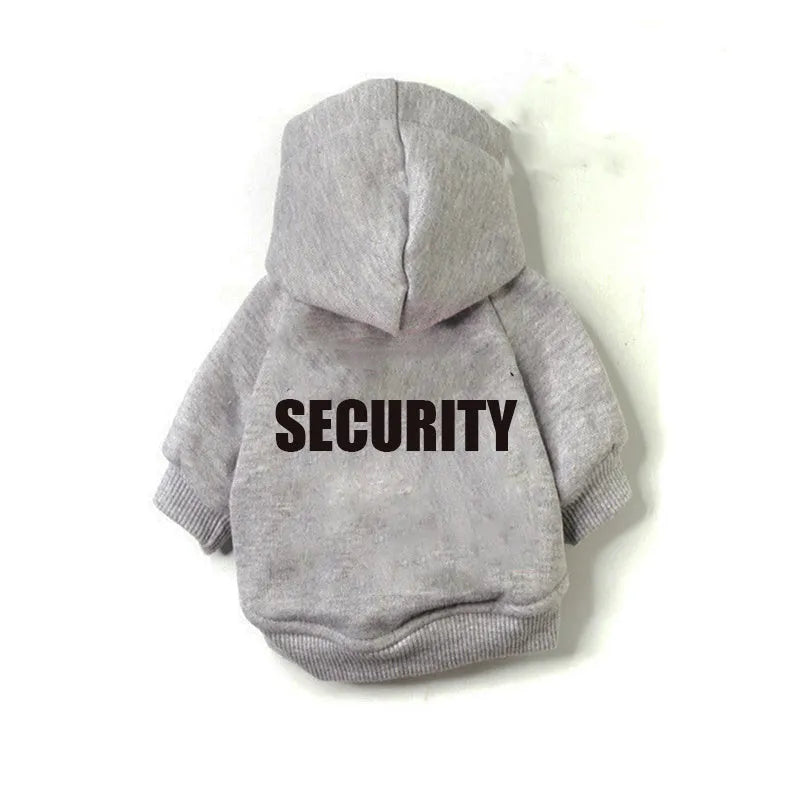 Small grey dog wearing a fleece pet sweater with hood, shown on a grassy area