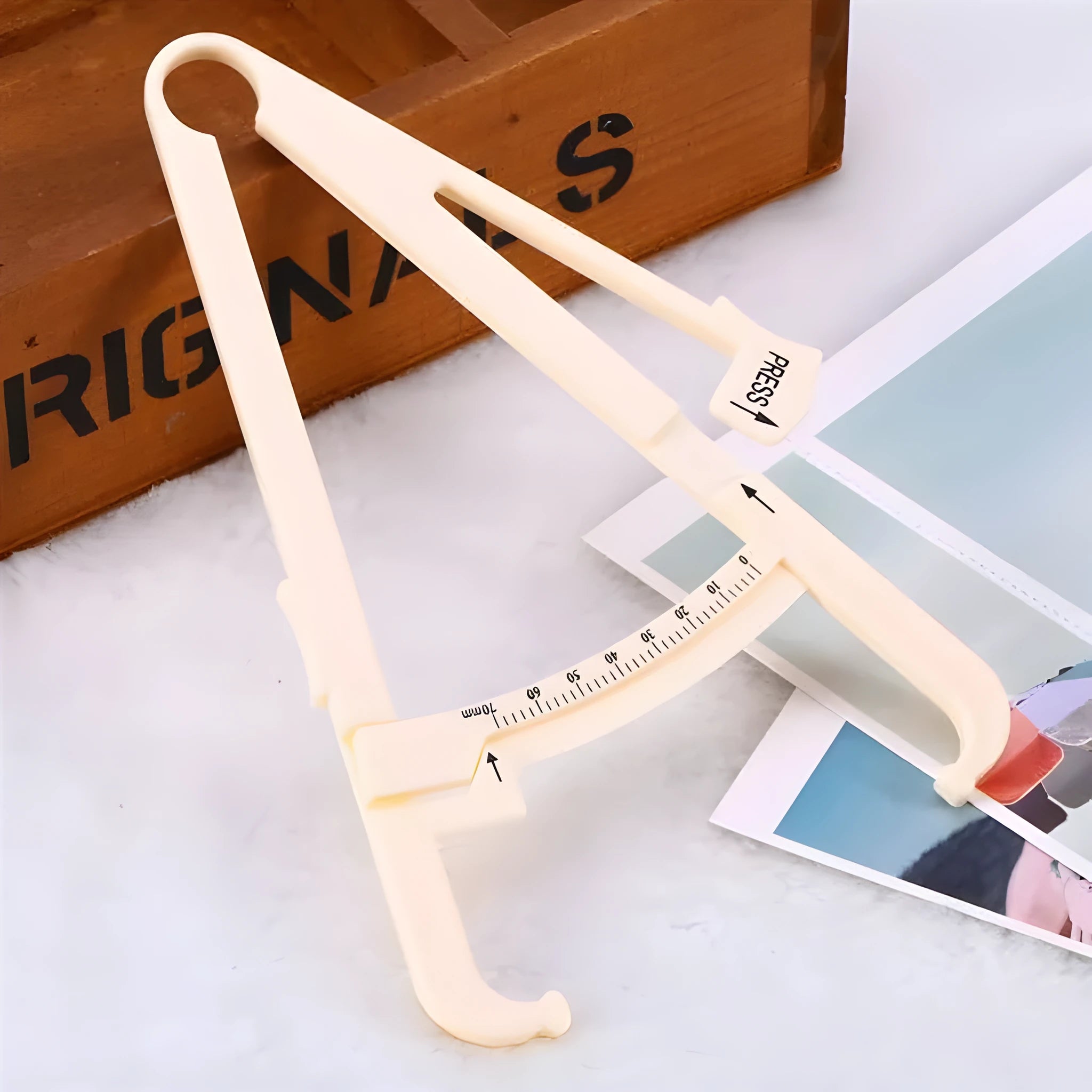 Acrylic body fat caliper skin fold thickness measuring instrument showing measurement scale