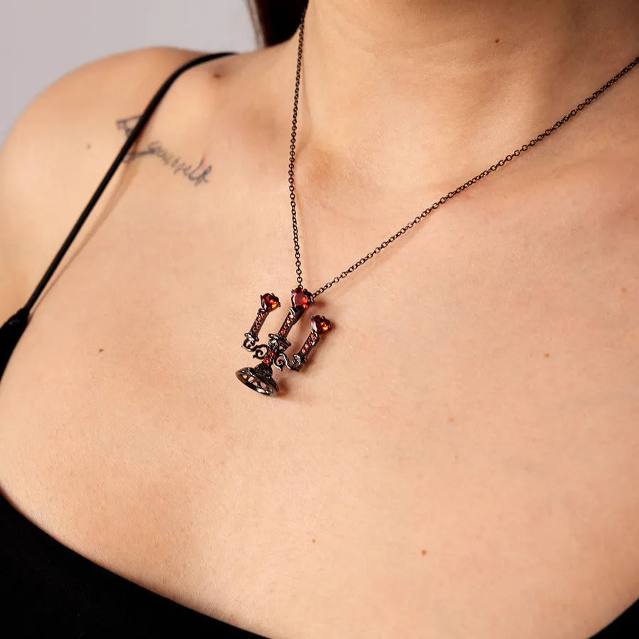 Gothic style zinc alloy clavicle chain necklace with a hollow candlestick pendant on a cross chain.