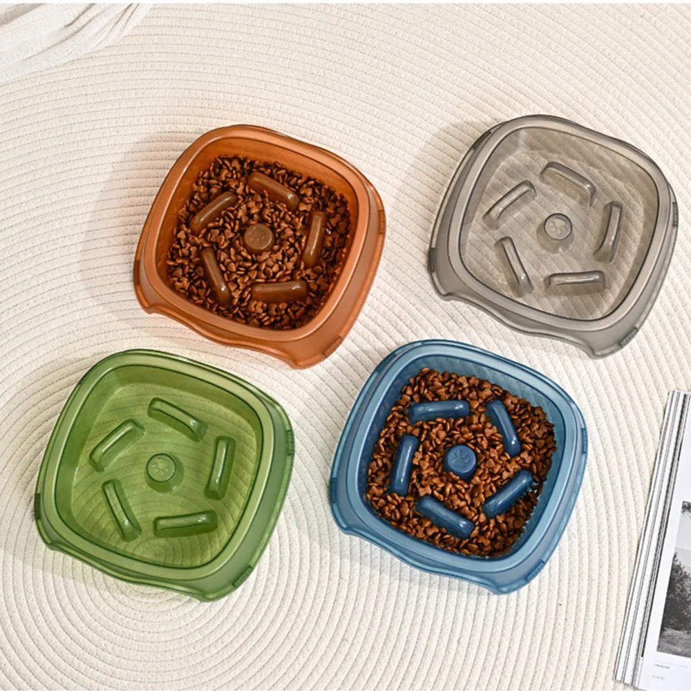 Blue plastic slow feeder dog bowl with anti-choking design on a white surface.