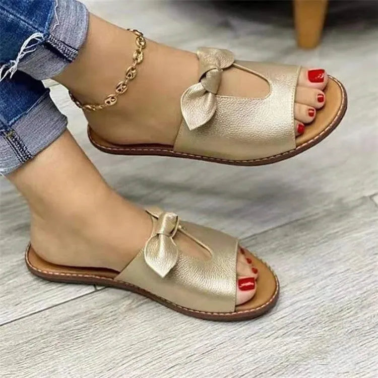 Ladies' black sandals with a fish mouth toe design and a decorative bow on the strap.