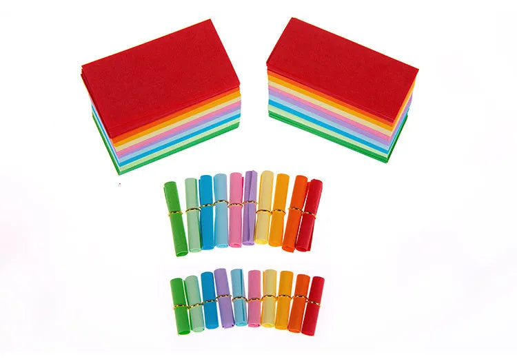 Assorted coloured mini paper scrolls with metal eyelets in sizes 3x7cm, 4x7cm, 5x5cm and 7x7cm.