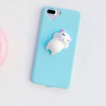 A soft pink silicone iPhone case featuring a raised 3D cartoon cat design on the back.