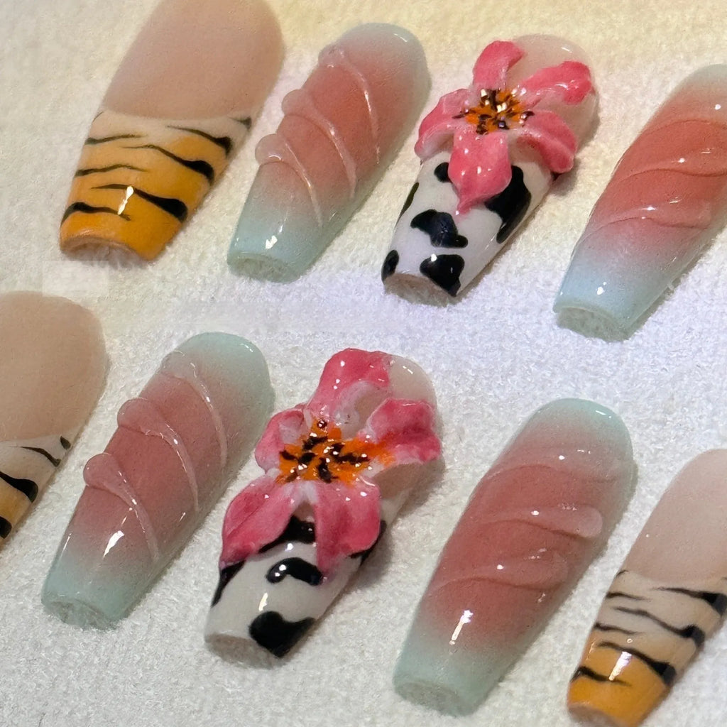 Embossed lily flower and leopard print zebra pattern nail art set showing dimensional texture and size variations