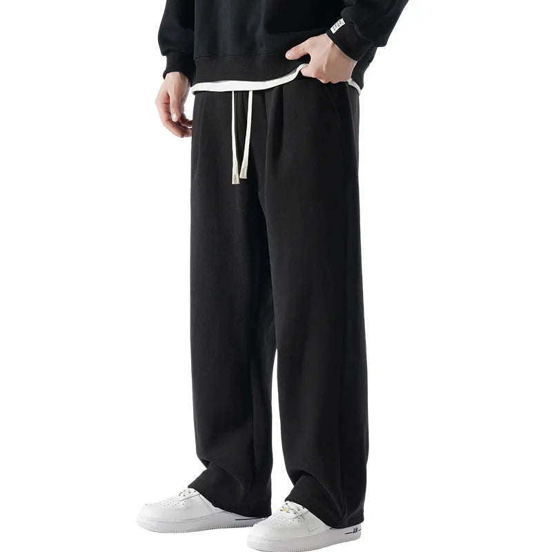 Men's apricot coloured loose-fit polar fleece trousers with a drawstring waistband, shown laid flat.