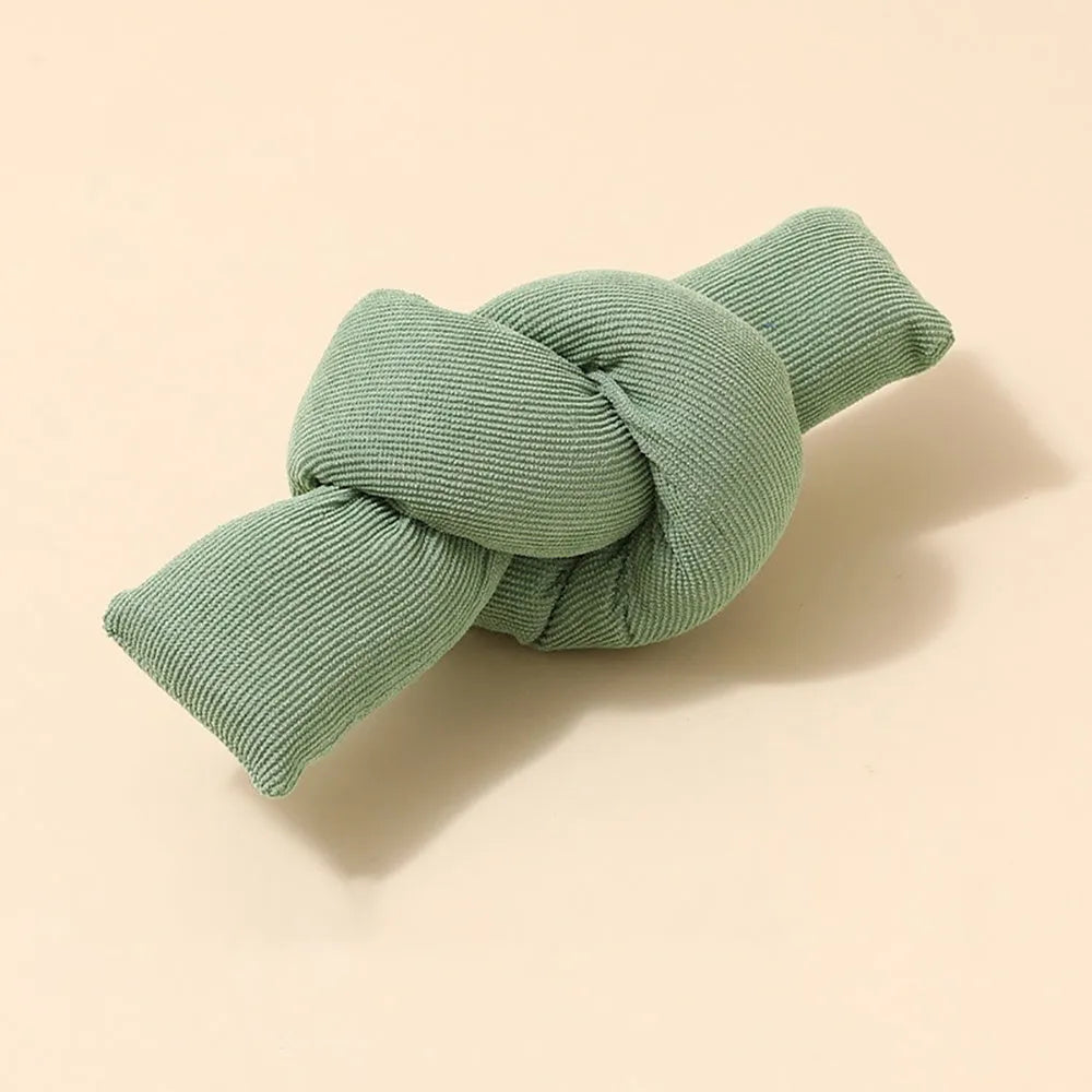 White knotted cotton rope dog toy for tugging and chewing.