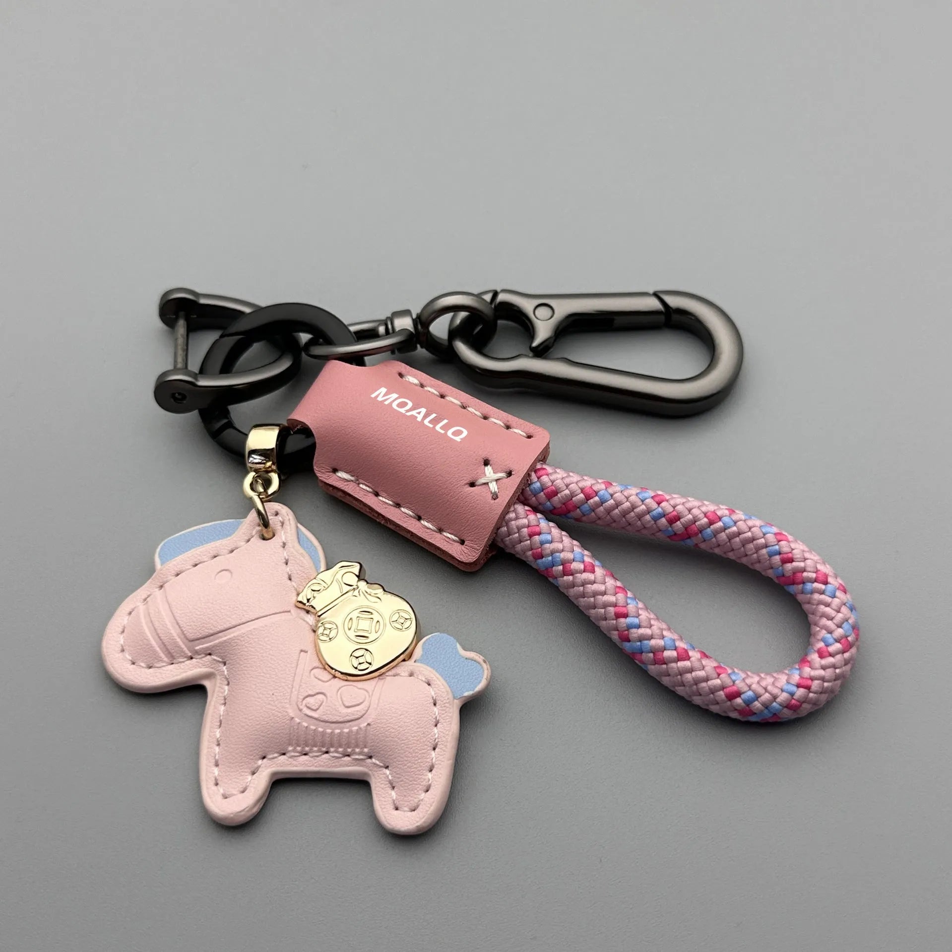 Handmade brown cowhide key pendant with a green flannel rope and a gold-toned horse-shaped buckle.